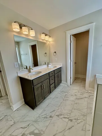 a spacious bathroom with a sink vanity and mirror