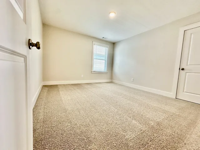 an empty room with a empty space and windows