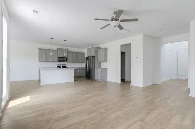 a view of a kitchen with a sink and a refrigerator
