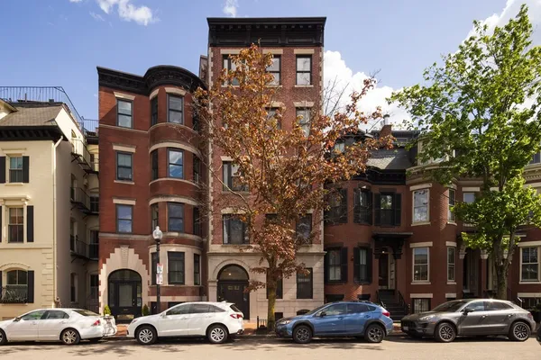 a couple of cars parked in front of a building
