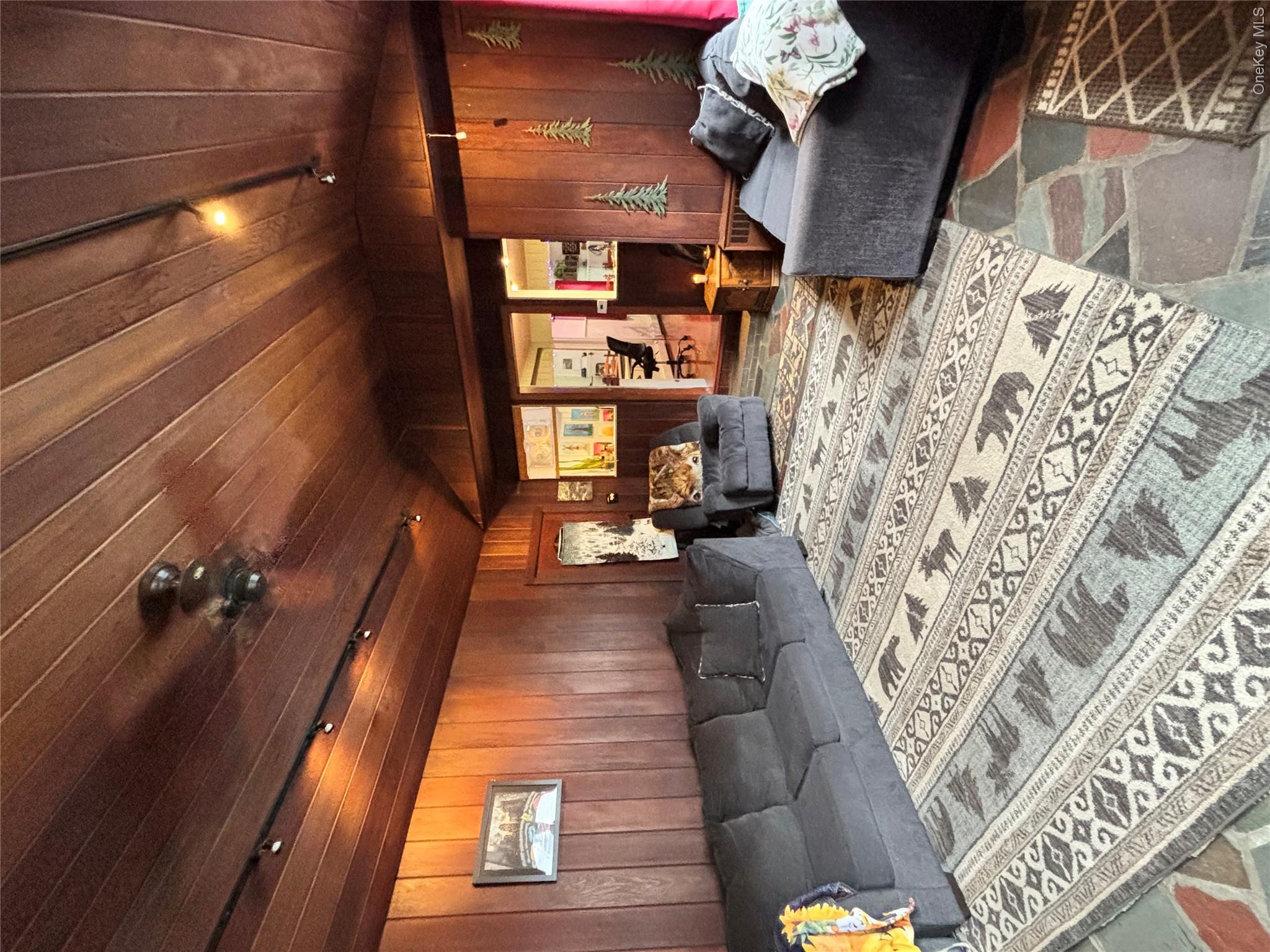 894 Upper Mountain Road Pine Bush, NY 12566 - Photo 12 of 35 Living room featuring lofted ceiling, wooden walls, wood ceiling, and rail lighting