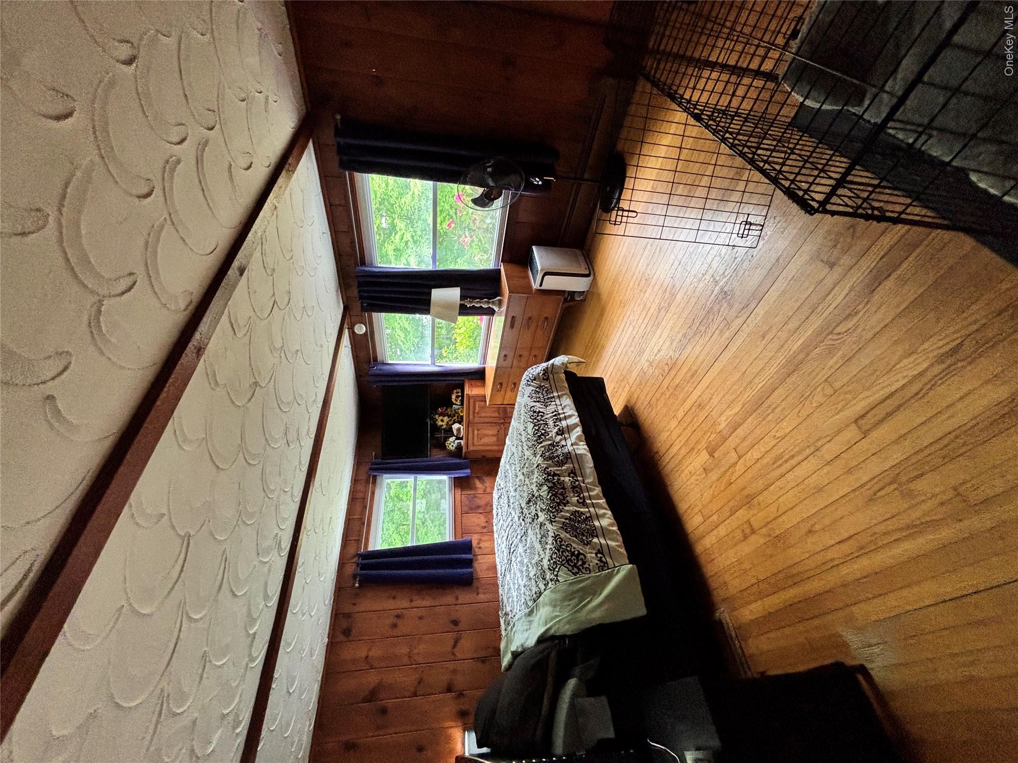 894 Upper Mountain Road Pine Bush, NY 12566 - Photo 17 of 35 Bedroom with wooden walls and light wood-type flooring