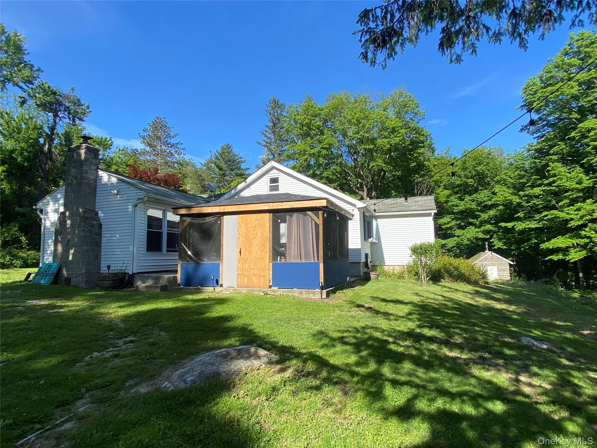 894 Upper Mountain Road Pine Bush, NY 12566 - Photo 25 of 35 Rear view of property with a sunroom, a yard, and a chimney