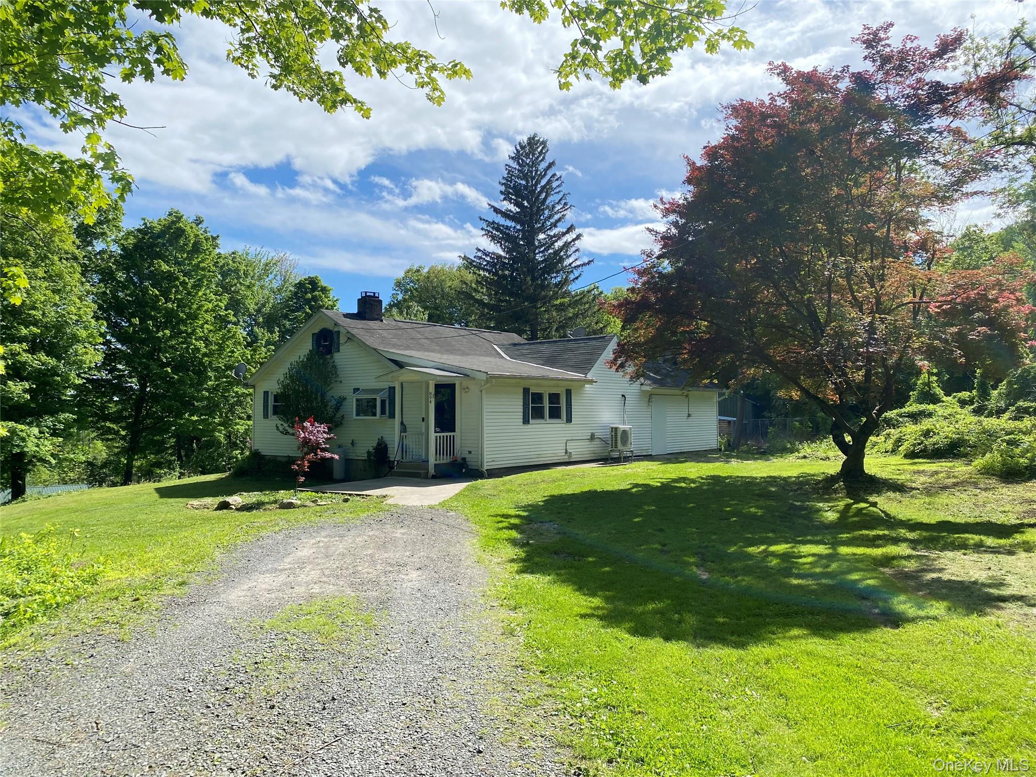 894 Upper Mountain Road Pine Bush, NY 12566 - Photo 3 of 35 View of front facade featuring gravel driveway, a chimney, a front lawn, and central AC