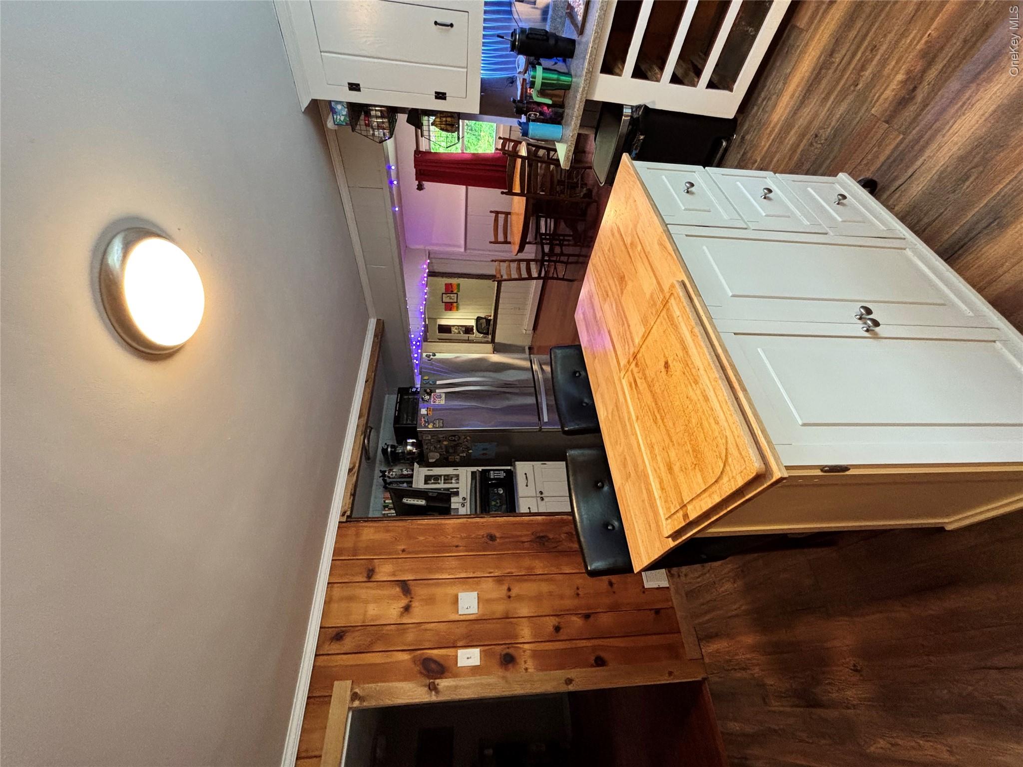 894 Upper Mountain Road Pine Bush, NY 12566 - Photo 5 of 35 Kitchen featuring wood counters, dark wood-type flooring, freestanding refrigerator, white cabinetry, and ornamental molding