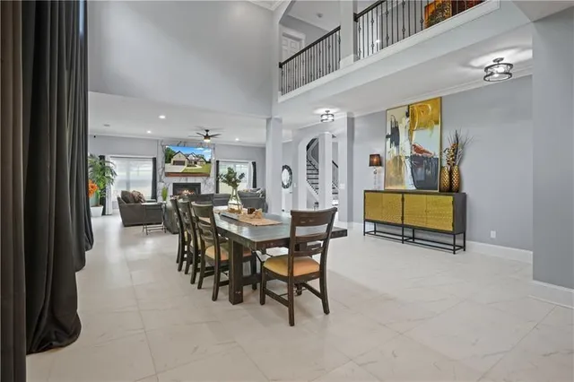 a living room with furniture a ceiling fan and a rug