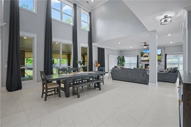 a kitchen with stainless steel appliances granite countertop a stove a sink a oven a dining table and chairs