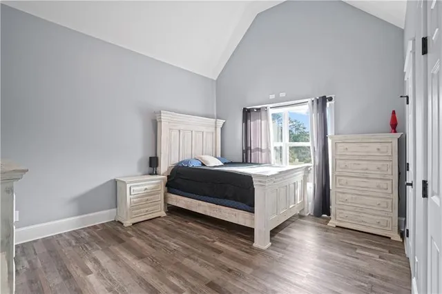 a bathroom with a granite countertop sink and a toilet