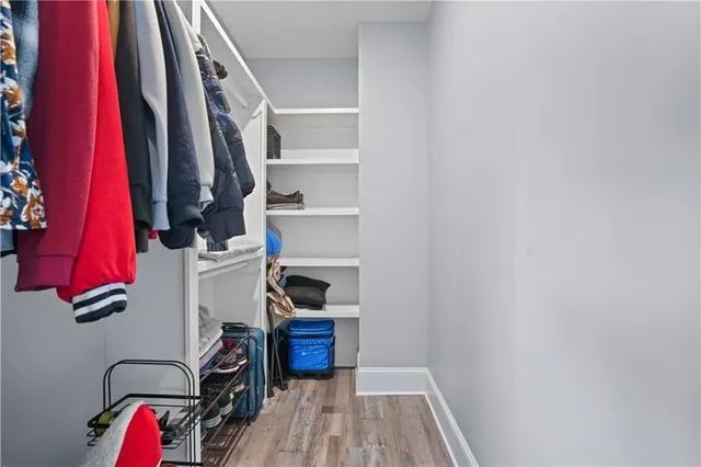 a kitchen with a table chairs a stove and a refrigerator
