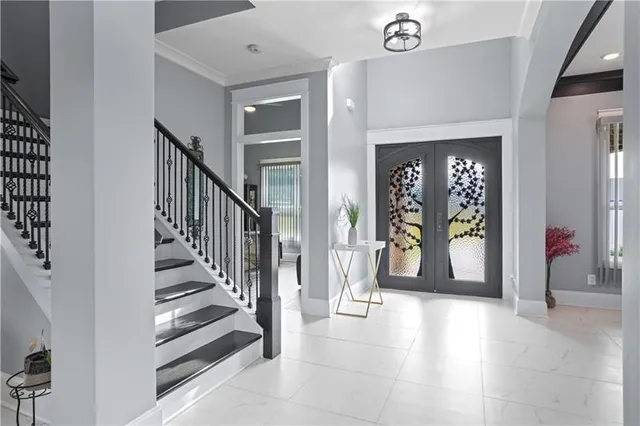 a view of a hallway with entryway wooden floor and door