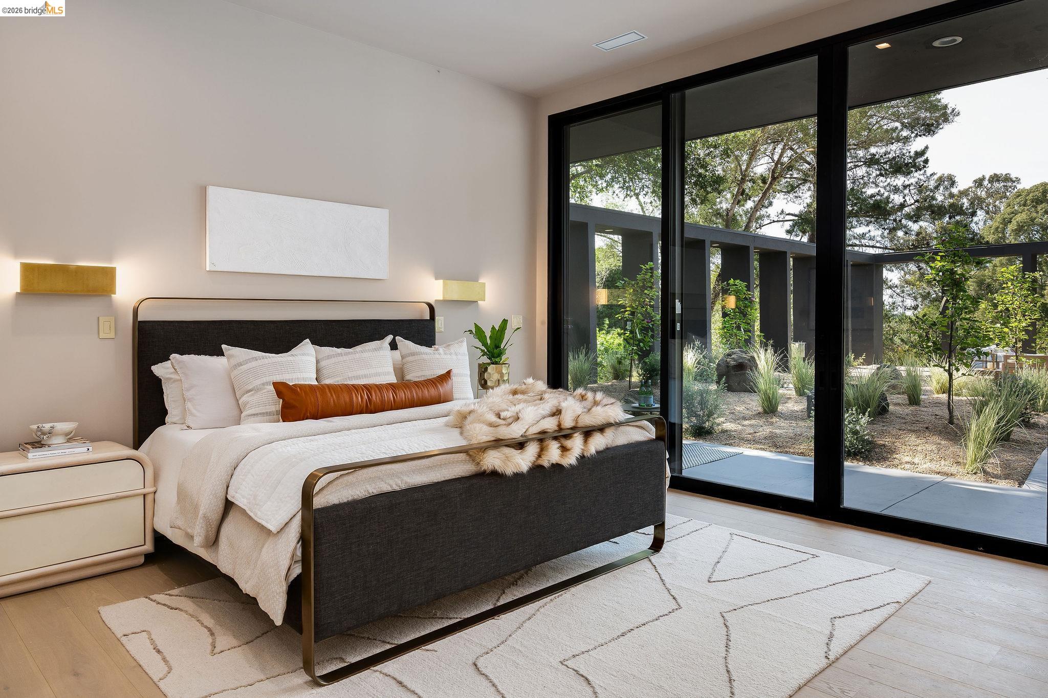 5645 Bacon Road Oakland, CA 94619 - Photo 64 of 94 Full-height sliding glass doors opening to an exterior patio with landscaping, light wood-finish flooring, and recessed ceiling lighting