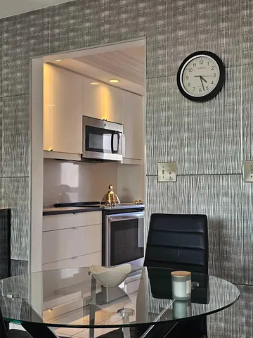 a kitchen with stainless steel appliances granite countertop a refrigerator a sink and a stove