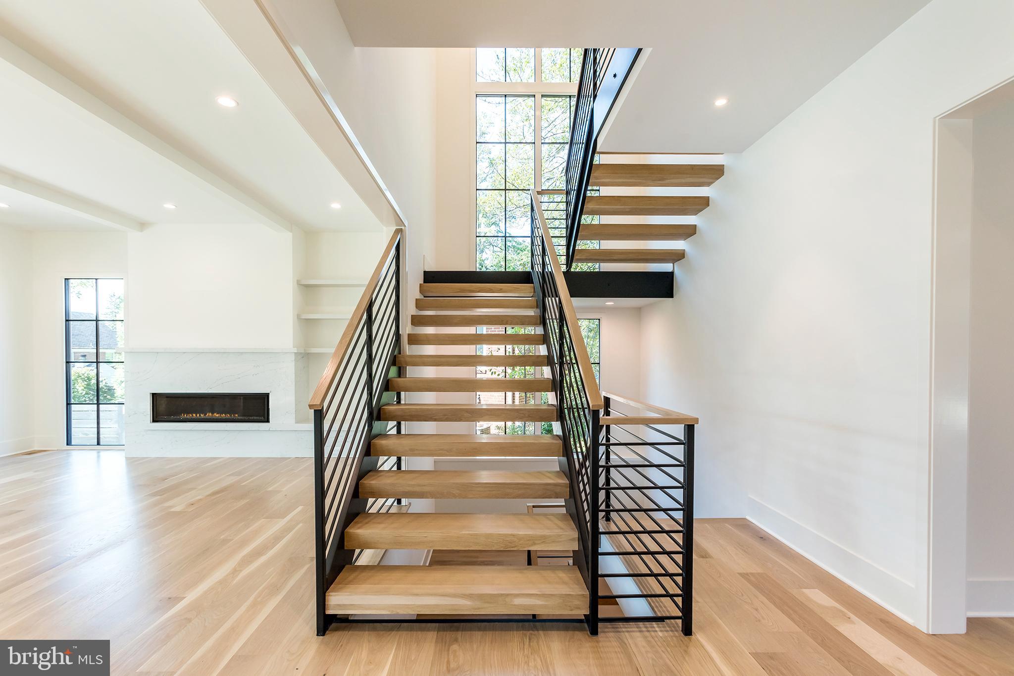 4610 Davidson Drive Chevy Chase, MD 20815 - Photo 11 of 75 Double height wall of windows frame the staircase