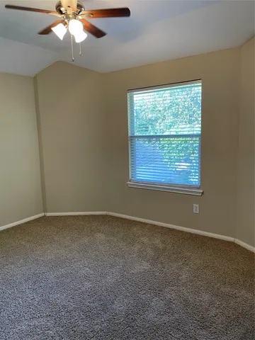 a view of a room with wooden floor and chandelier