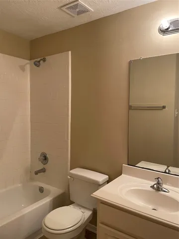 a bathroom with a toilet and a bath tub