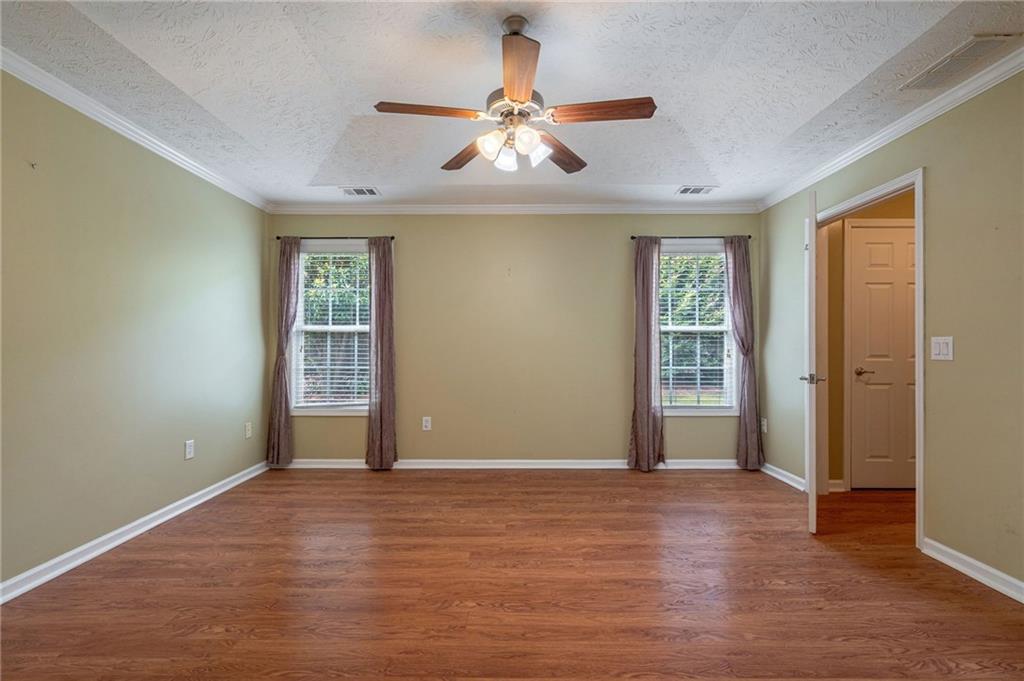 245 Memory Lane Winder, GA 30680 - Photo 24 of 62 an empty room with wooden floor and windows