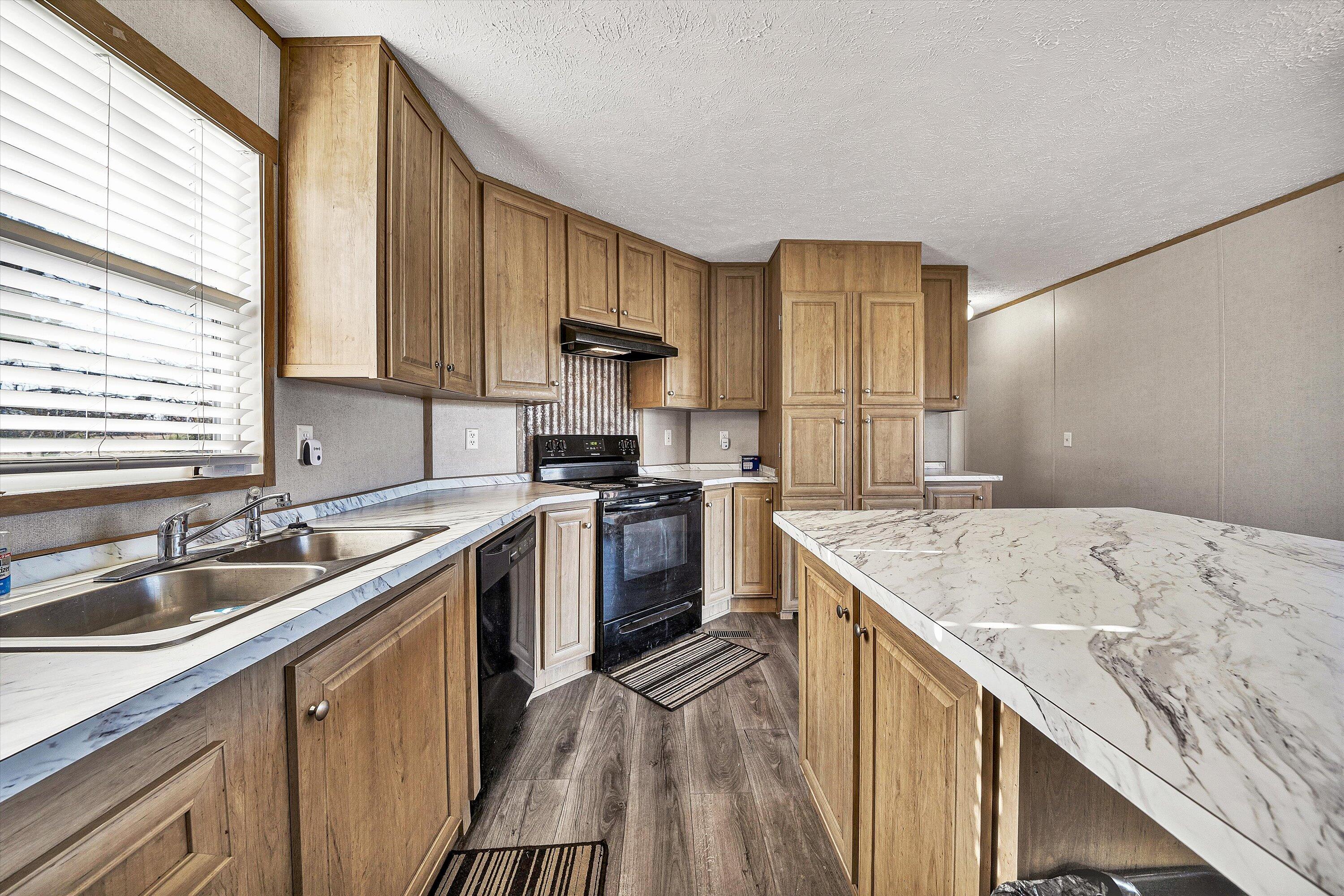 1405 Doe Run Road Rocky Mount, VA 24151 - Photo 11 of 27 a kitchen with a sink stove top oven and cabinets