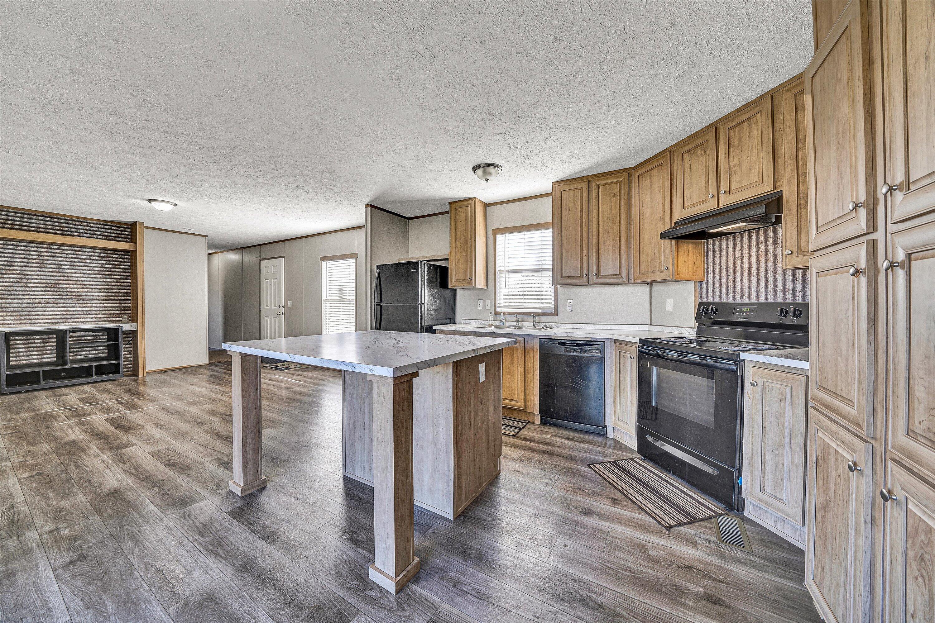1405 Doe Run Road Rocky Mount, VA 24151 - Photo 12 of 27 a kitchen with granite countertop a sink stove and refrigerator