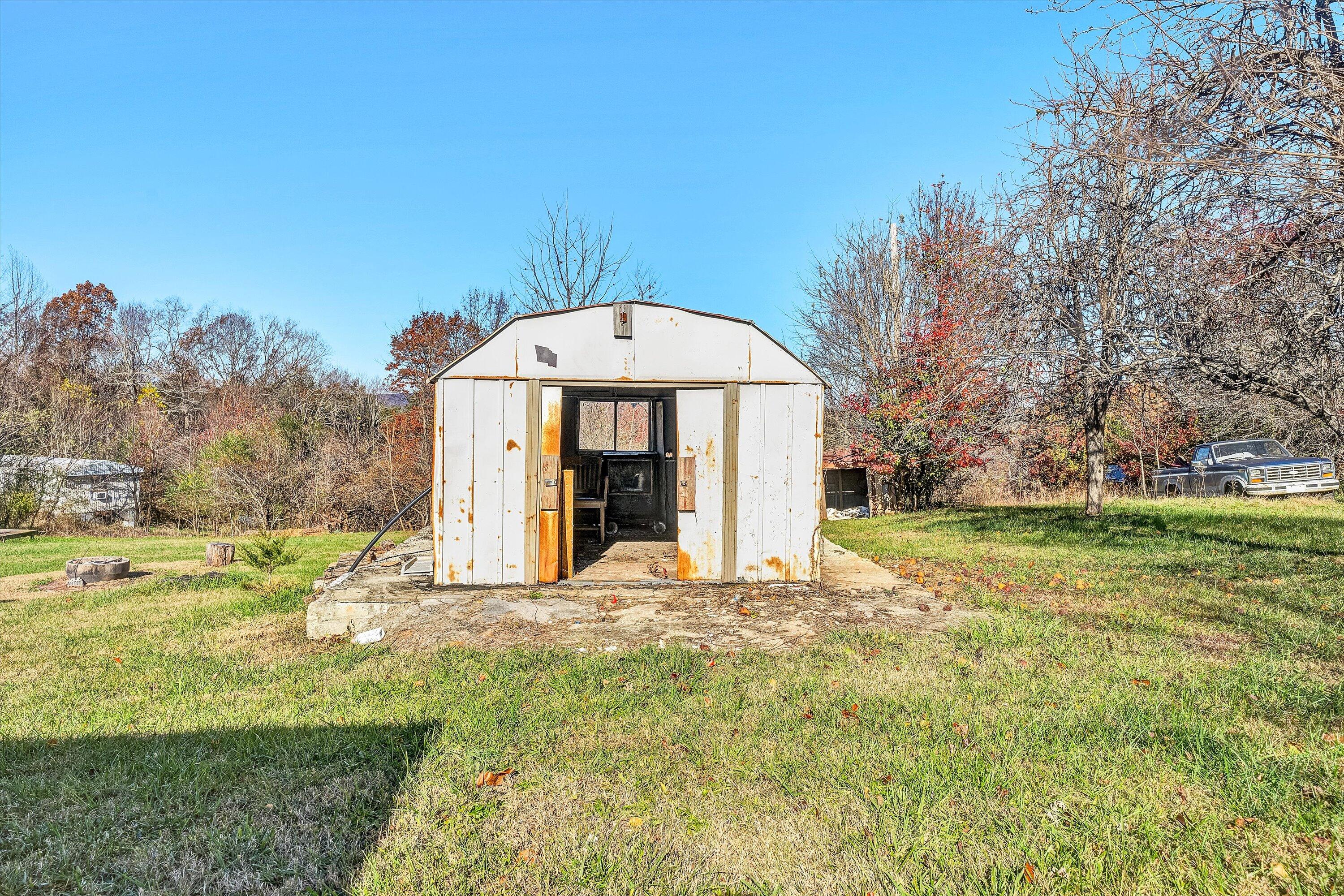 1405 Doe Run Road Rocky Mount, VA 24151 - Photo 25 of 27 a view of a house with backyard and trees