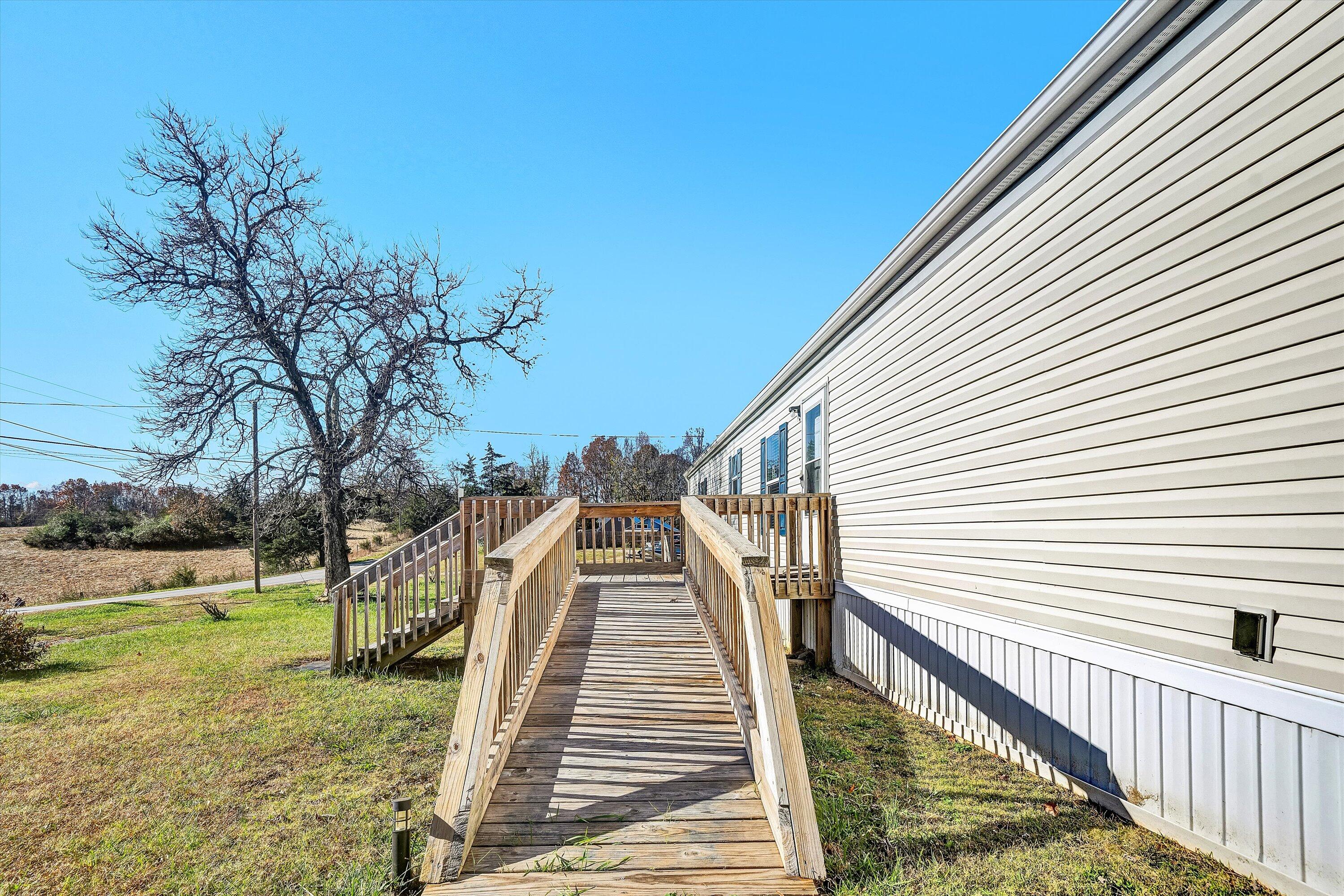 1405 Doe Run Road Rocky Mount, VA 24151 - Photo 3 of 27 a view of a house with backyard and trees
