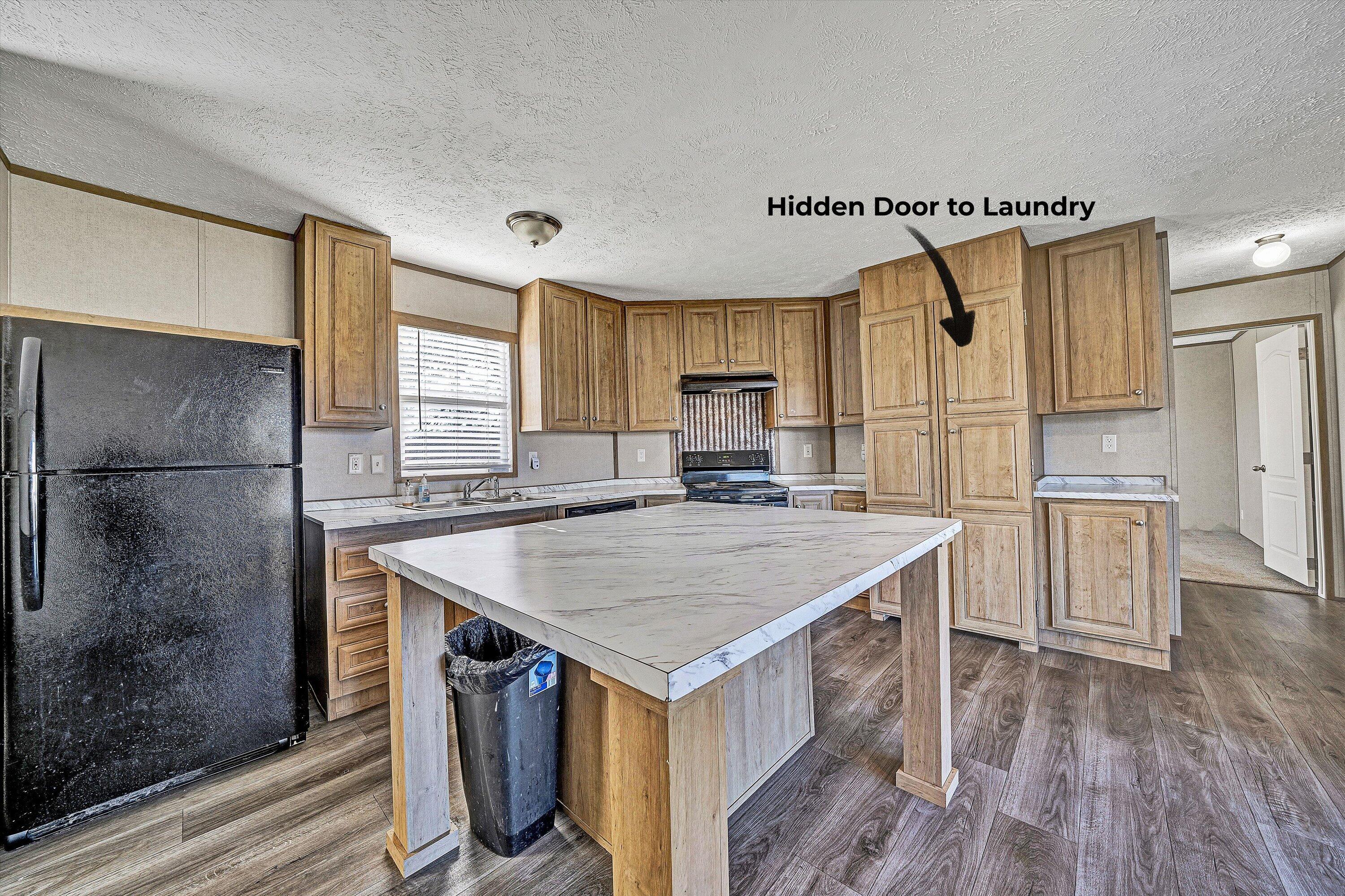 1405 Doe Run Road Rocky Mount, VA 24151 - Photo 8 of 27 a kitchen with a stove a refrigerator and a wooden floor
