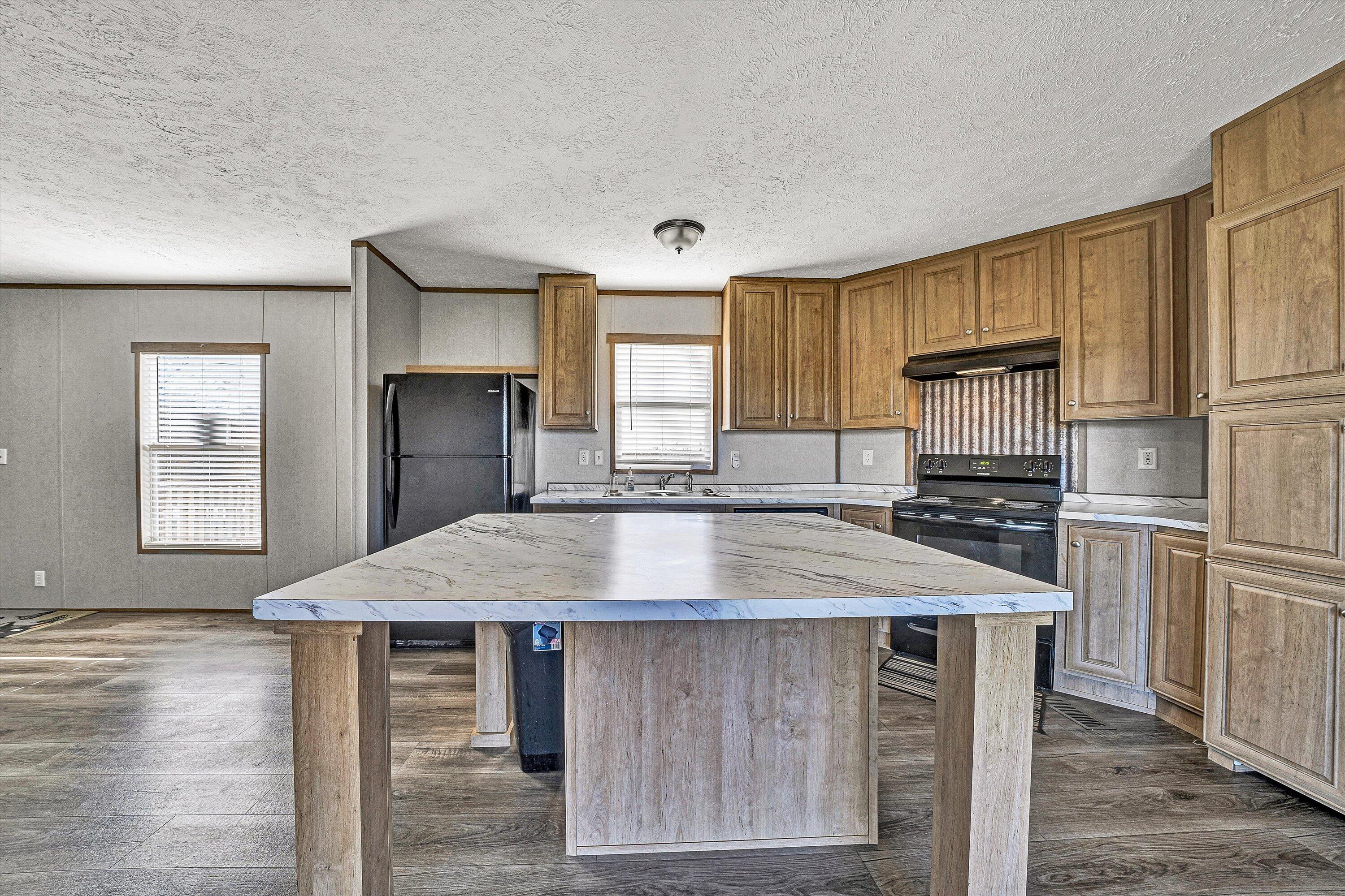 1405 Doe Run Road Rocky Mount, VA 24151 - Photo 10 of 27 a kitchen with kitchen island a counter top space cabinets and stainless steel appliances