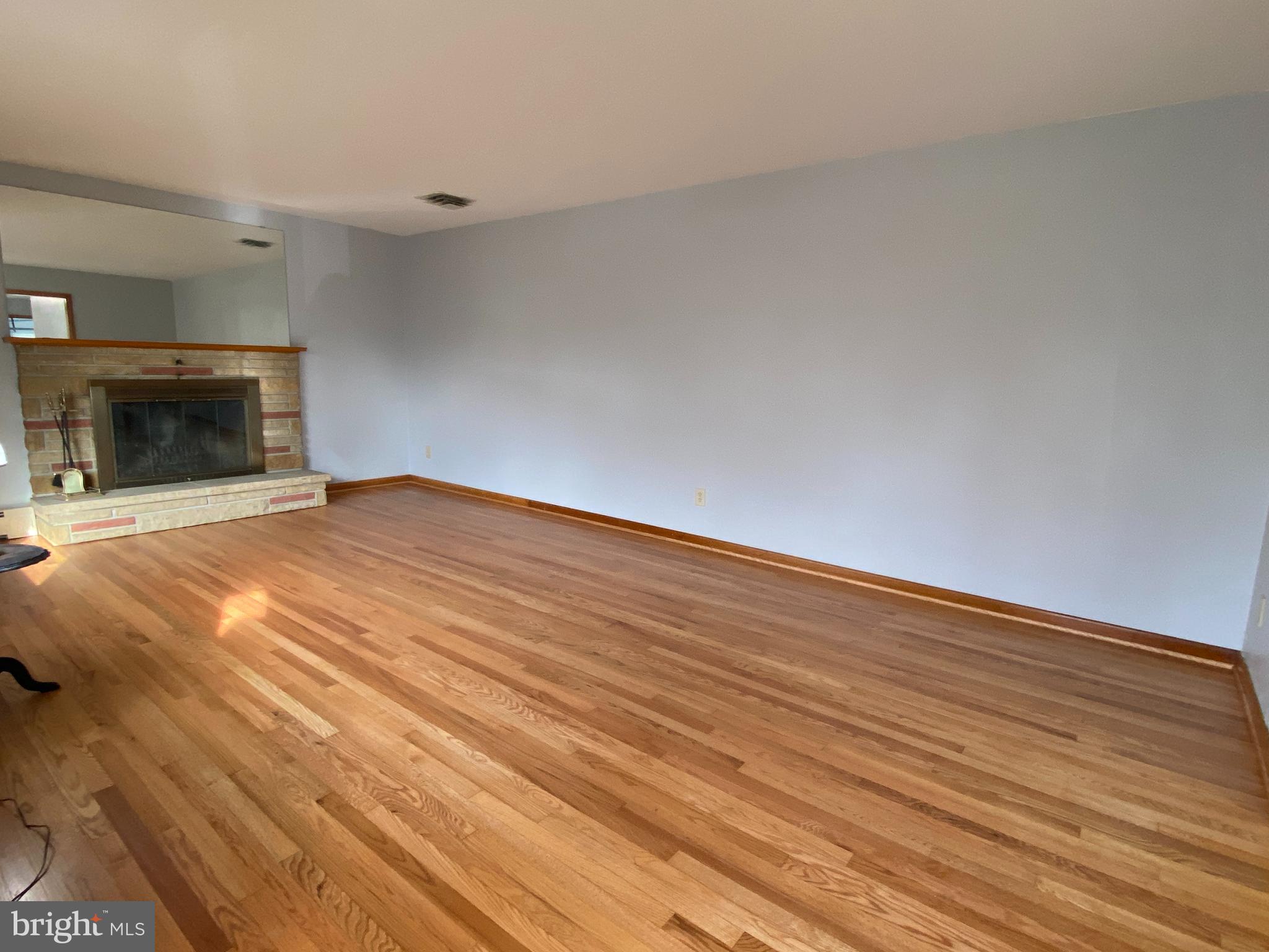 13343 Keener Road Hagerstown, MD 21742 - Photo 17 of 56 a view of an empty room with wooden floor and a fireplace