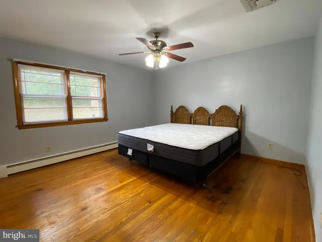 a view of hallway with wooden floor