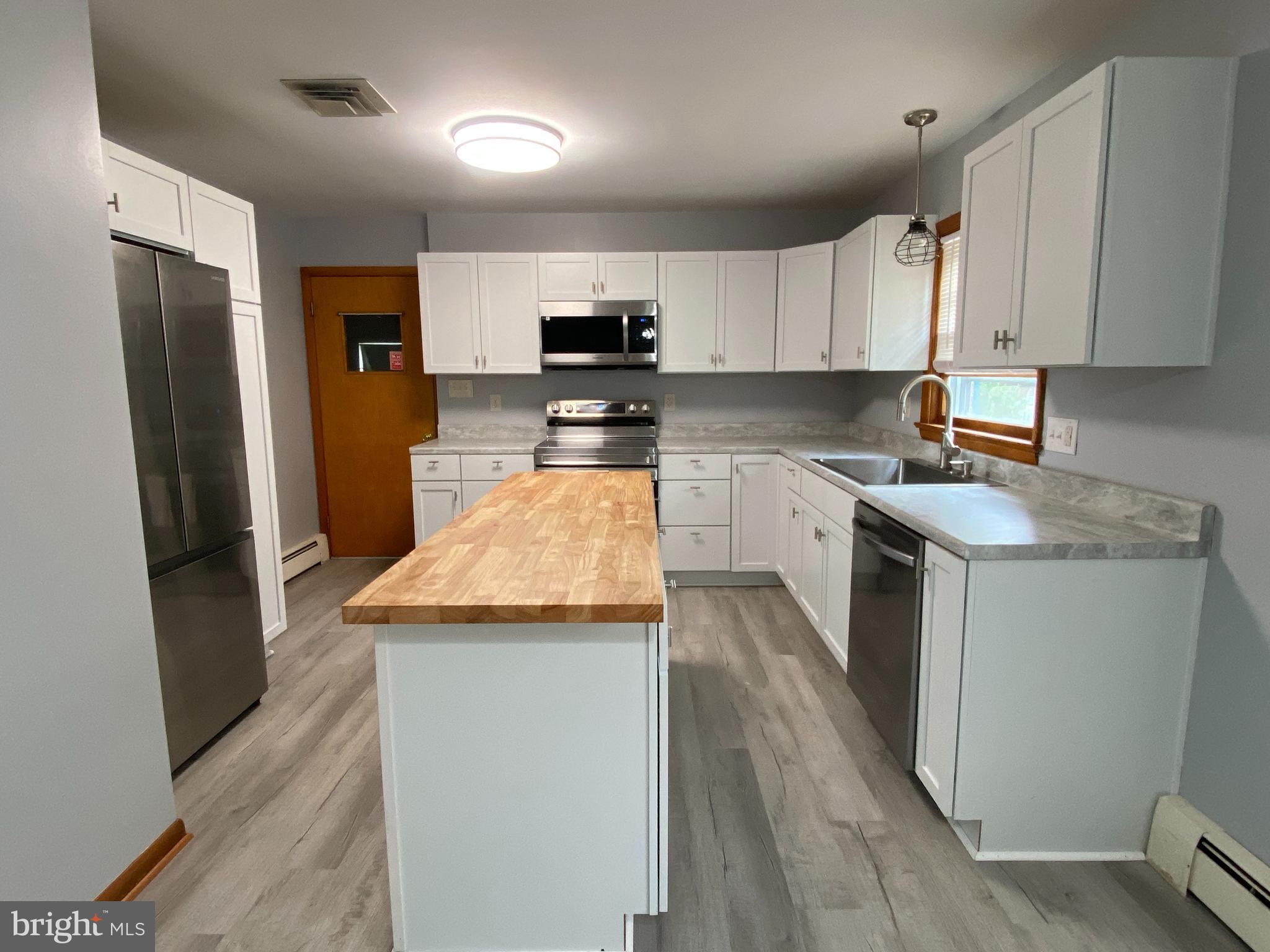 13343 Keener Road Hagerstown, MD 21742 - Photo 3 of 56 a kitchen with stainless steel appliances granite countertop a refrigerator a sink dishwasher a stove top oven a refrigerator and white cabinets