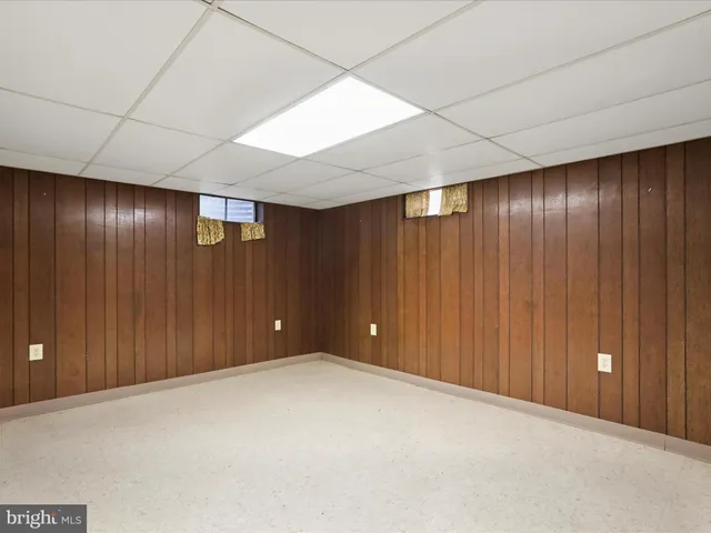a view of a house with a big yard potted plants and large tree