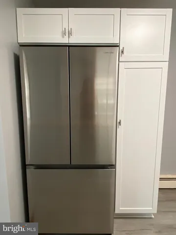 a kitchen with stainless steel appliances granite countertop a white refrigerator a stove top oven a sink and dishwasher