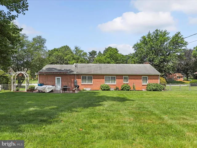 an aerial view of a house with yard