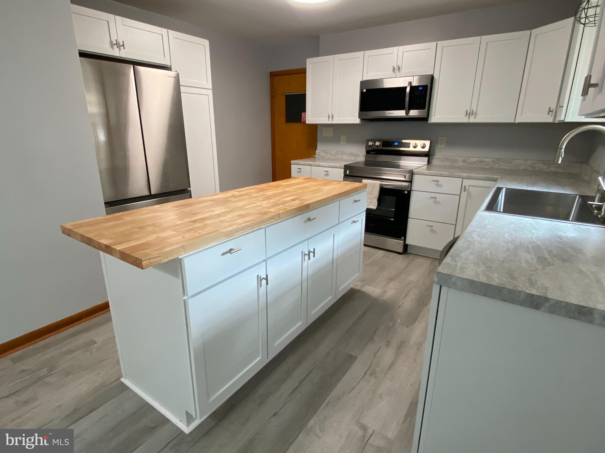 13343 Keener Road Hagerstown, MD 21742 - Photo 5 of 56 a kitchen with stainless steel appliances granite countertop a white refrigerator a stove top oven a sink and dishwasher