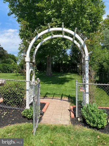 a view of green field with trees in the background