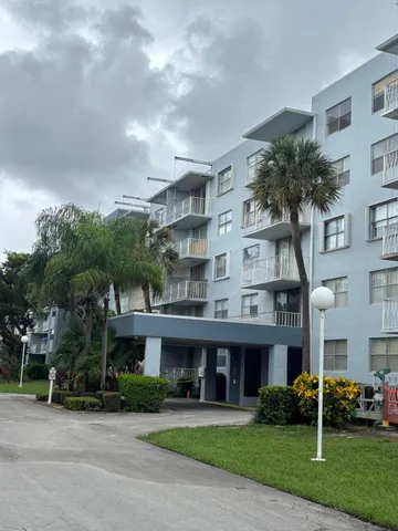 a front view of a building with garden
