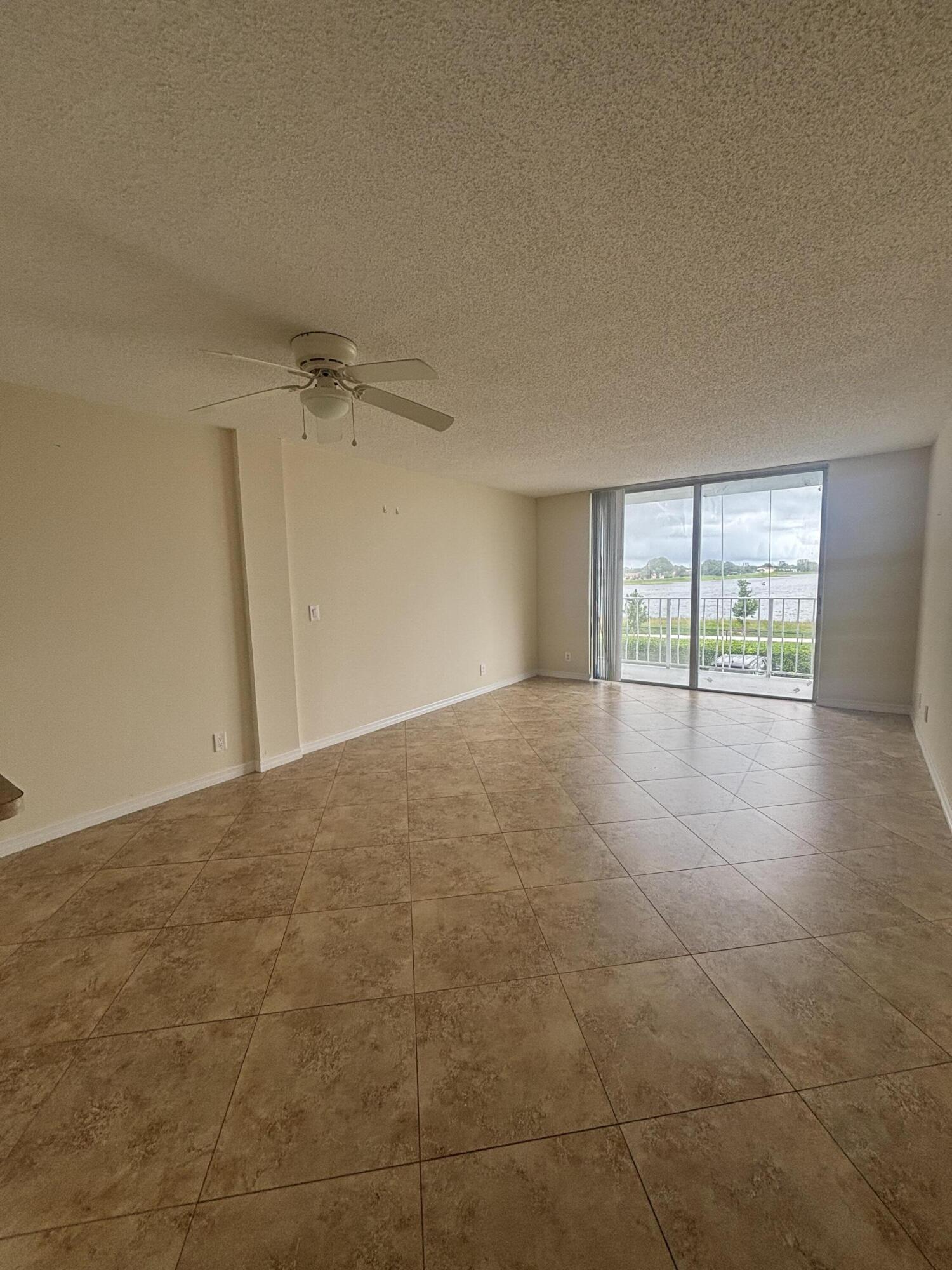 480 Executive Center Drive, Unit 2C West Palm Beach, FL 33401 - Photo 13 of 18 wooden floor in an empty room with a window
