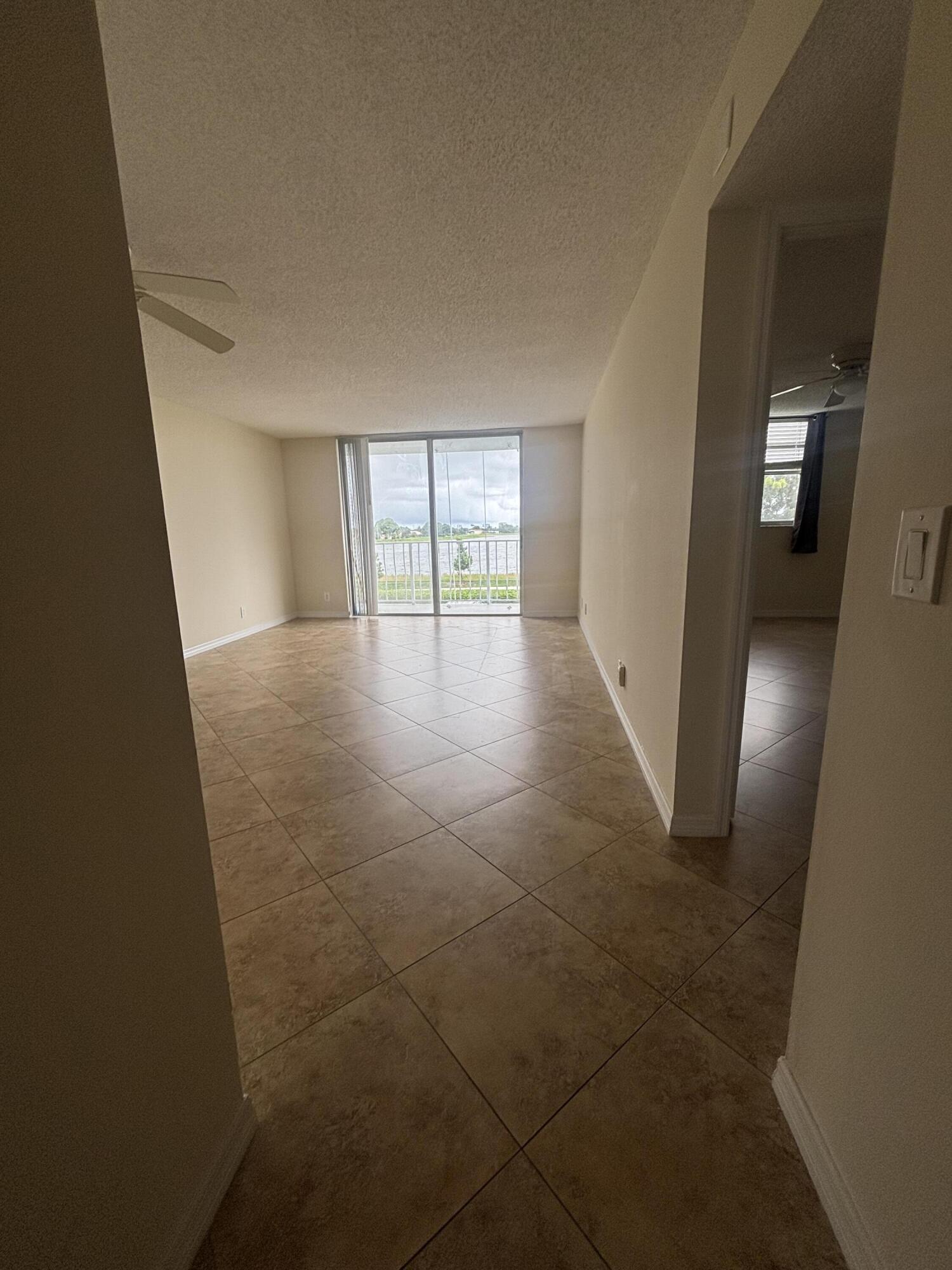 480 Executive Center Drive, Unit 2C West Palm Beach, FL 33401 - Photo 14 of 18 wooden floor in an empty room with a window