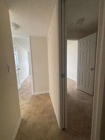 a bathroom with a granite countertop toilet sink and mirror