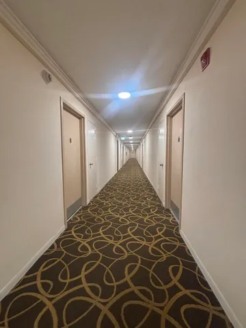 a kitchen with stainless steel appliances a stove a sink and white cabinets