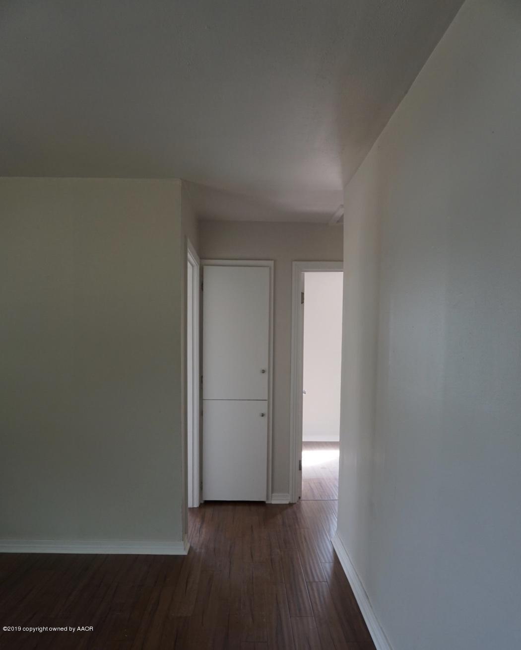 4608 Cline Road Amarillo, TX 79110 - Photo 11 of 14 an empty room with wooden floor and closet