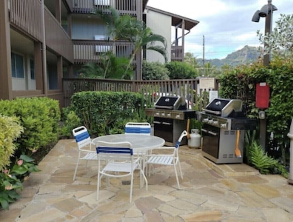 320 Papaloa Road, Unit 302 Kapaa, HI 96746 - Photo 14 of 16 a view of a patio with a table and chairs