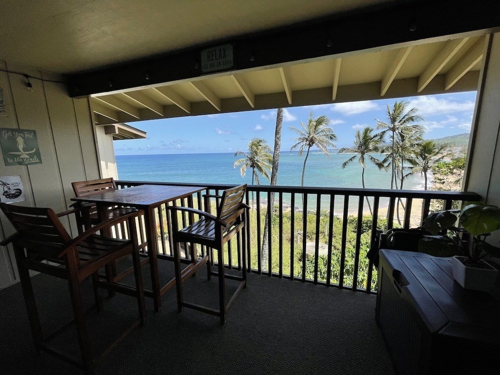 320 Papaloa Road, Unit 302 Kapaa, HI 96746 - Photo 2 of 16 a view of a patio with a table and chairs