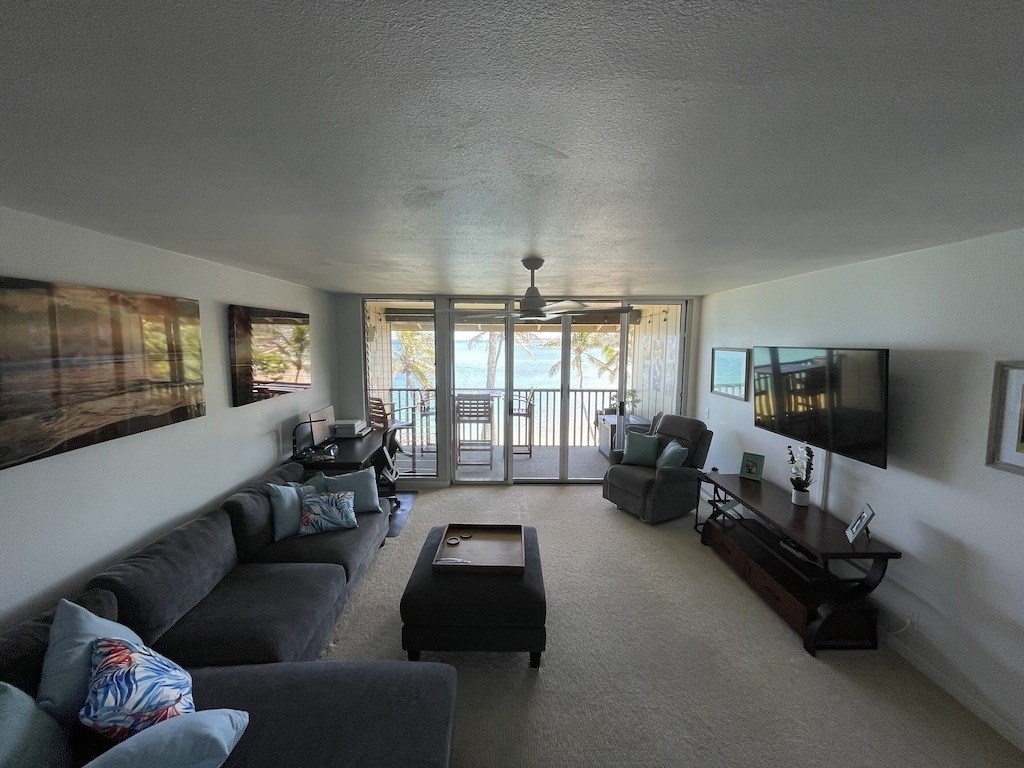 320 Papaloa Road, Unit 302 Kapaa, HI 96746 - Photo 5 of 16 a living room with furniture and a flat screen tv