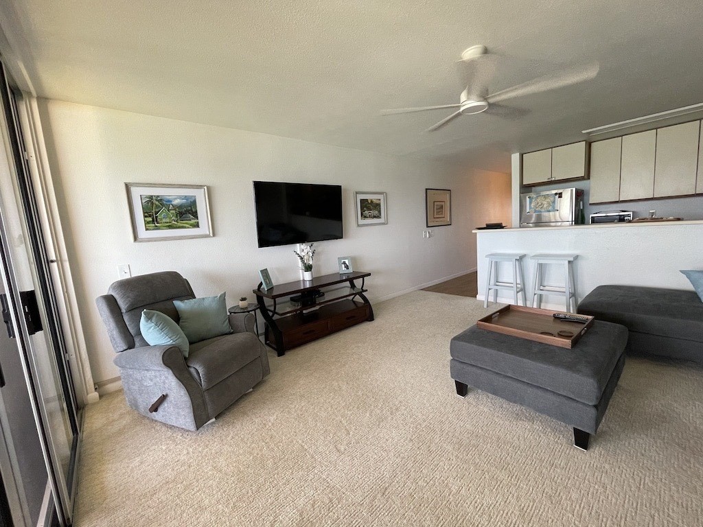 320 Papaloa Road, Unit 302 Kapaa, HI 96746 - Photo 6 of 16 a living room with furniture and a flat screen tv