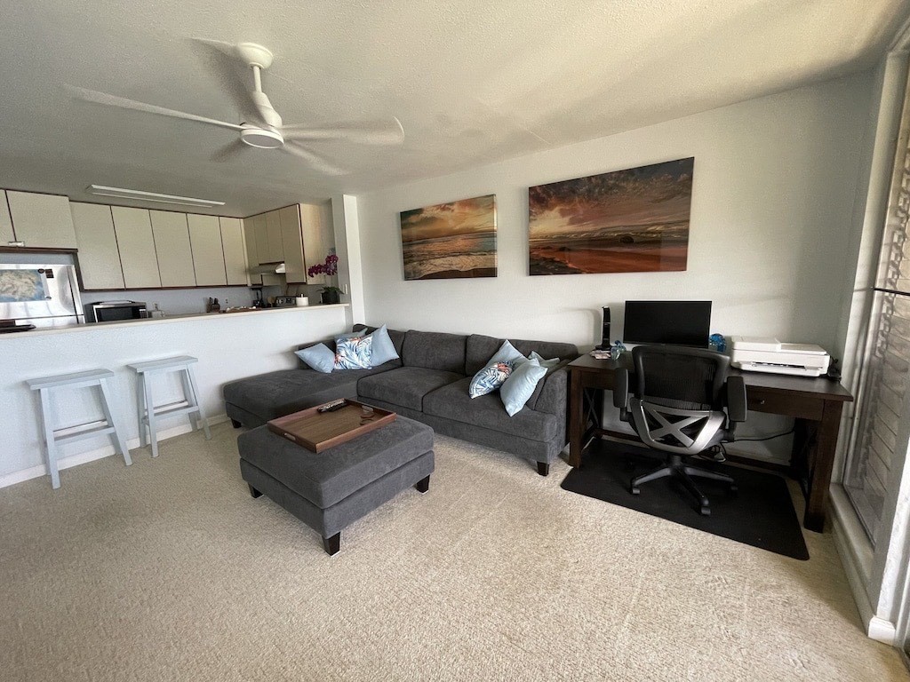 320 Papaloa Road, Unit 302 Kapaa, HI 96746 - Photo 7 of 16 a living room with furniture and a flat screen tv