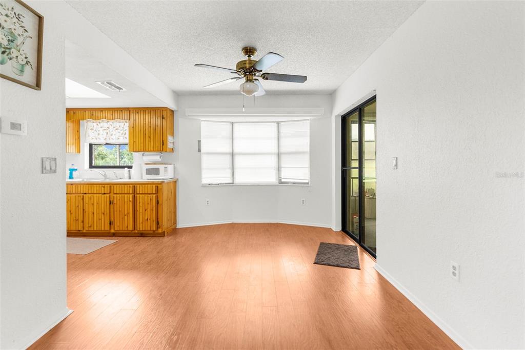 22249 Powell Road Brooksville, FL 34601 - Photo 19 of 43 wooden floor in an empty room with a window