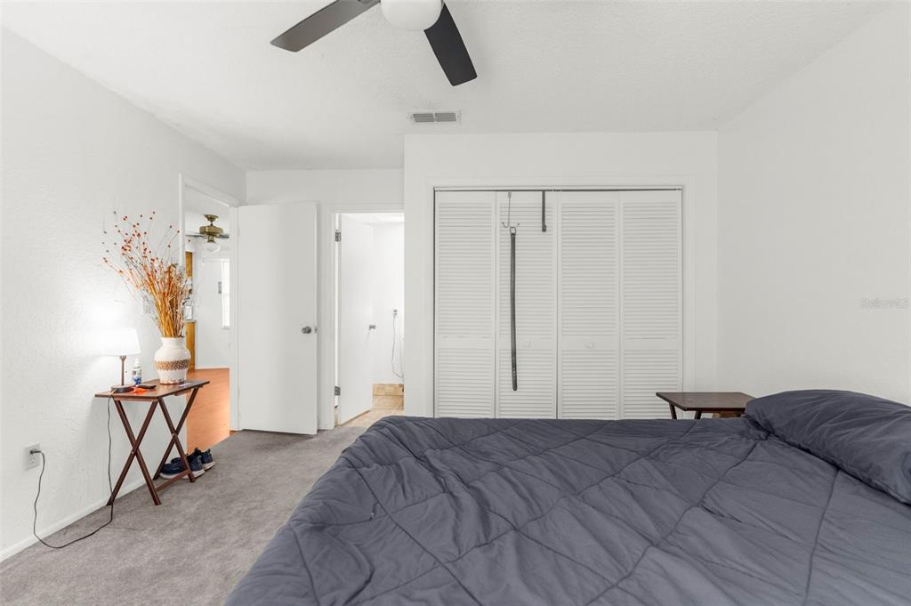 22249 Powell Road Brooksville, FL 34601 - Photo 26 of 43 a bedroom with a bed and a chair