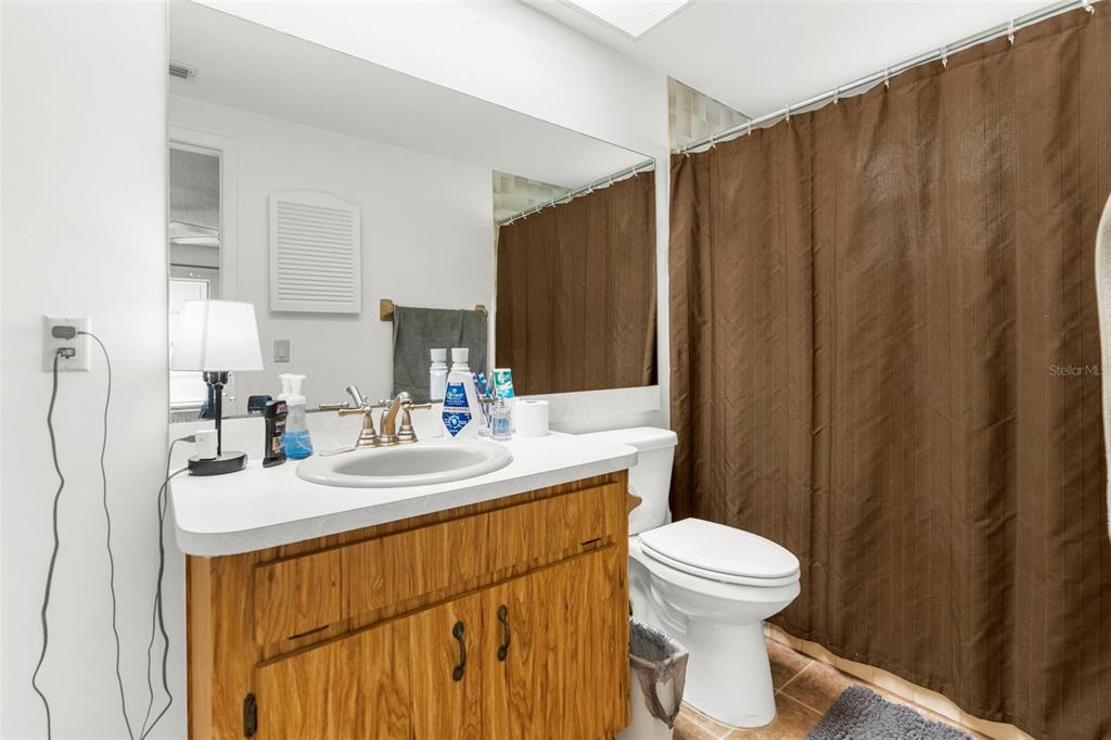 22249 Powell Road Brooksville, FL 34601 - Photo 27 of 43 a bathroom with a sink a toilet and mirror