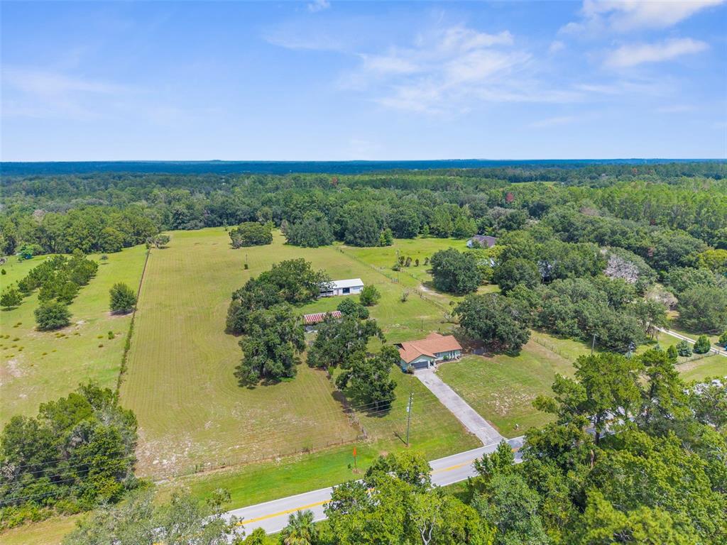 22249 Powell Road Brooksville, FL 34601 - Photo 3 of 43 an aerial view of a houses with yard