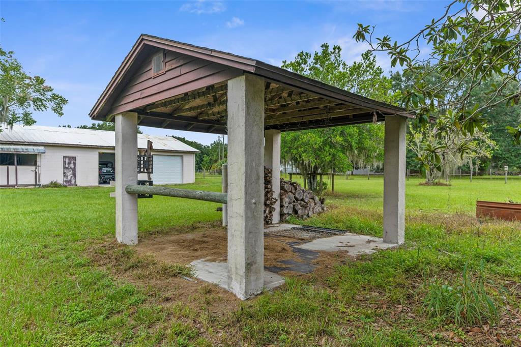 22249 Powell Road Brooksville, FL 34601 - Photo 33 of 43 a view of a house with backyard and a garden